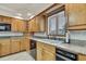 Kitchen featuring oak cabinets, granite countertops, and stainless steel appliances at 5747 Fieldspring Ave, New Port Richey, FL 34655