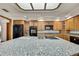 Bright kitchen showcasing a large island with granite countertop and built-in cooktop at 5747 Fieldspring Ave, New Port Richey, FL 34655
