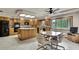 Bright and airy kitchen with island, oak cabinets, and adjacent dining area at 5747 Fieldspring Ave, New Port Richey, FL 34655
