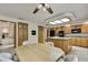Well-lit kitchen and adjacent dining area featuring oak cabinets and a central island at 5747 Fieldspring Ave, New Port Richey, FL 34655