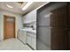 Well-equipped laundry area with modern appliances, a sink, and storage cabinets at 5747 Fieldspring Ave, New Port Richey, FL 34655