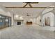 Bright living room with tile floors, stone fireplace, ceiling fan, archway, and doors to the pool at 5747 Fieldspring Ave, New Port Richey, FL 34655