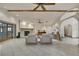 Inviting living room with stone fireplace, ceiling fan, tile flooring, neutral furniture, and an archway at 5747 Fieldspring Ave, New Port Richey, FL 34655