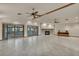 Expansive living room features a stone fireplace, doors to the pool, and tile flooring at 5747 Fieldspring Ave, New Port Richey, FL 34655