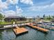 Aerial view of the backyard featuring a screened-in patio and canal access with private boat dock at 6601 Nautical Isle, Hudson, FL 34667