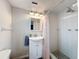 Bright bathroom featuring white tiled shower, modern vanity with storage, and updated fixtures at 6601 Nautical Isle, Hudson, FL 34667
