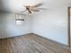 Bright bedroom with ceiling fan, wood-look floors, and large window at 6601 Nautical Isle, Hudson, FL 34667