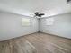 Neutral bedroom with ceiling fan, wood-look floors, and natural light at 6601 Nautical Isle, Hudson, FL 34667