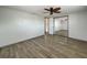 Bright bedroom featuring wood-look floors and sliding mirror closet doors at 6601 Nautical Isle, Hudson, FL 34667
