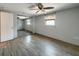 Bright bedroom featuring wood-look floors and sliding mirror closet doors at 6601 Nautical Isle, Hudson, FL 34667