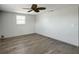 Bright bedroom featuring wood-look floors and a ceiling fan at 6601 Nautical Isle, Hudson, FL 34667