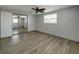 Bright bedroom featuring wood-look floors and sliding mirror closet doors at 6601 Nautical Isle, Hudson, FL 34667