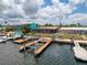 Aerial view of a boat lift on the canal with a waterfront view of neighboring properties and docks at 6601 Nautical Isle, Hudson, FL 34667