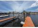 View of boat lift on the canal featuring sturdy supports and adjacent docks in a waterfront setting at 6601 Nautical Isle, Hudson, FL 34667