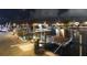 Night view of the private dock featuring an elevated platform with accent lighting and city lights at 6601 Nautical Isle, Hudson, FL 34667