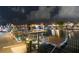 Well-lit dock with a seating area, perfect for enjoying waterfront views and accessing boating amenities at 6601 Nautical Isle, Hudson, FL 34667