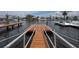 View of a dock on the canal with a sturdy metal rail, and houses in the background at 6601 Nautical Isle, Hudson, FL 34667