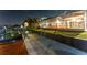 Exterior showcasing a waterfront property with a screened-in lanai, grassy lawn, and convenient access to the canal at 6601 Nautical Isle, Hudson, FL 34667