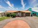 Charming waterfront home featuring a circular driveway and a vibrant copper-colored roof at 6601 Nautical Isle, Hudson, FL 34667