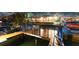 Exterior view of a waterfront home featuring a screened enclosure and boat dock, blending indoor-outdoor living at 6601 Nautical Isle, Hudson, FL 34667