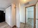 Hallway with closet and doorway to a bright room, featuring wood-look floors at 6601 Nautical Isle, Hudson, FL 34667