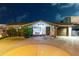 Charming single-story home with well-manicured landscaping, a circular driveway, and an attached garage at twilight at 6601 Nautical Isle, Hudson, FL 34667