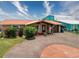 Charming single-story home with manicured landscaping, a circular driveway, and an attached garage at 6601 Nautical Isle, Hudson, FL 34667
