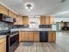 Well-appointed kitchen boasting granite countertops, wood cabinets, and updated appliances at 6601 Nautical Isle, Hudson, FL 34667