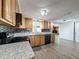 Modern kitchen with granite counters, wood cabinets, and stainless steel appliances at 6601 Nautical Isle, Hudson, FL 34667