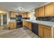 Well-lit kitchen featuring wooden cabinets, granite countertops, stainless steel appliances, and gray backsplash at 6601 Nautical Isle, Hudson, FL 34667