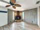 Living room with unique stone fireplace and wood-look flooring at 6601 Nautical Isle, Hudson, FL 34667