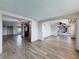 Spacious living room with wood-look tile flooring, open floor plan, and ample natural light at 6601 Nautical Isle, Hudson, FL 34667