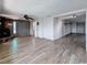 Open concept living room featuring wood-look floors and stone fireplace at 6601 Nautical Isle, Hudson, FL 34667