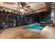 Charming screened pool with decorative surfboard and humorous signage, creating a unique and playful atmosphere at 6601 Nautical Isle, Hudson, FL 34667