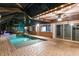 Inviting pool area featuring brick patio, covered area with ceiling fan, and a view of the canal at 6601 Nautical Isle, Hudson, FL 34667