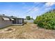 A view of the backyard and a screened-in porch. A privacy fence is located in the back at 6633 Jackson St, New Port Richey, FL 34653
