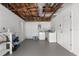 Finished basement with laundry area, storage, and white painted walls and floor at 6633 Jackson St, New Port Richey, FL 34653