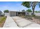 Exterior of house features a garage and a well-kept lawn with a paved driveway on a sunny day at 6633 Jackson St, New Port Richey, FL 34653