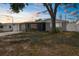 Charming single-story home with a covered carport and a screened-in porch at sunset at 6633 Jackson St, New Port Richey, FL 34653