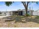 Charming single-story home with a covered carport and a screened-in porch at 6633 Jackson St, New Port Richey, FL 34653