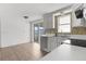 Bright kitchen featuring white cabinets, stainless steel appliances, and sliding glass door access at 6633 Jackson St, New Port Richey, FL 34653