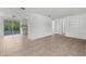 Living room shows tile flooring, natural light, and open layout connecting to kitchen at 6633 Jackson St, New Port Richey, FL 34653