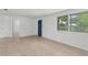 Bright living room offers tile flooring, a large window, and neutral walls, creating a welcoming space at 6633 Jackson St, New Port Richey, FL 34653