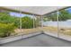 Enclosed porch with a view of the green backyard and garden at 6633 Jackson St, New Port Richey, FL 34653