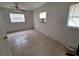 A vacant bedroom features tile flooring and bright natural light at 7100 Ashwood Dr, Port Richey, FL 34668