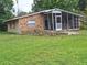 The exterior features a stone facade and a screened-in porch at 7100 Ashwood Dr, Port Richey, FL 34668