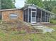 Charming stone cottage featuring a covered porch perfect for relaxing outdoors in a natural setting at 7100 Ashwood Dr, Port Richey, FL 34668