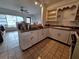 Cozy kitchen with white cabinetry and a seamless flow into the sunroom perfect for entertaining at 7100 Ashwood Dr, Port Richey, FL 34668