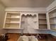 The kitchen has white cabinets, open shelving and a double bowl sink at 7100 Ashwood Dr, Port Richey, FL 34668