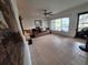 Spacious living room area featuring tile floors and a ceiling fan at 7100 Ashwood Dr, Port Richey, FL 34668